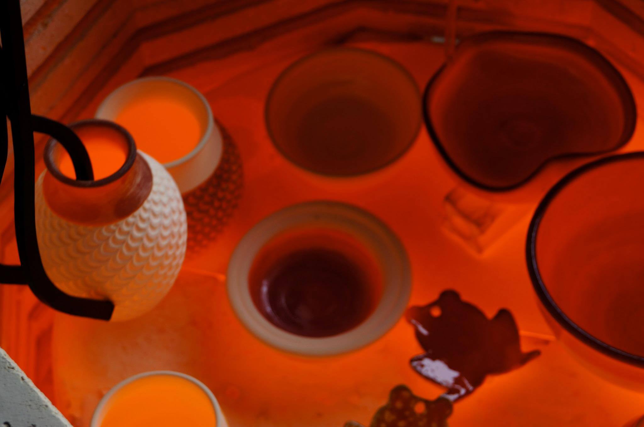 Raku pots glowing in kiln Raku pots are glowing red-hot in the kiln